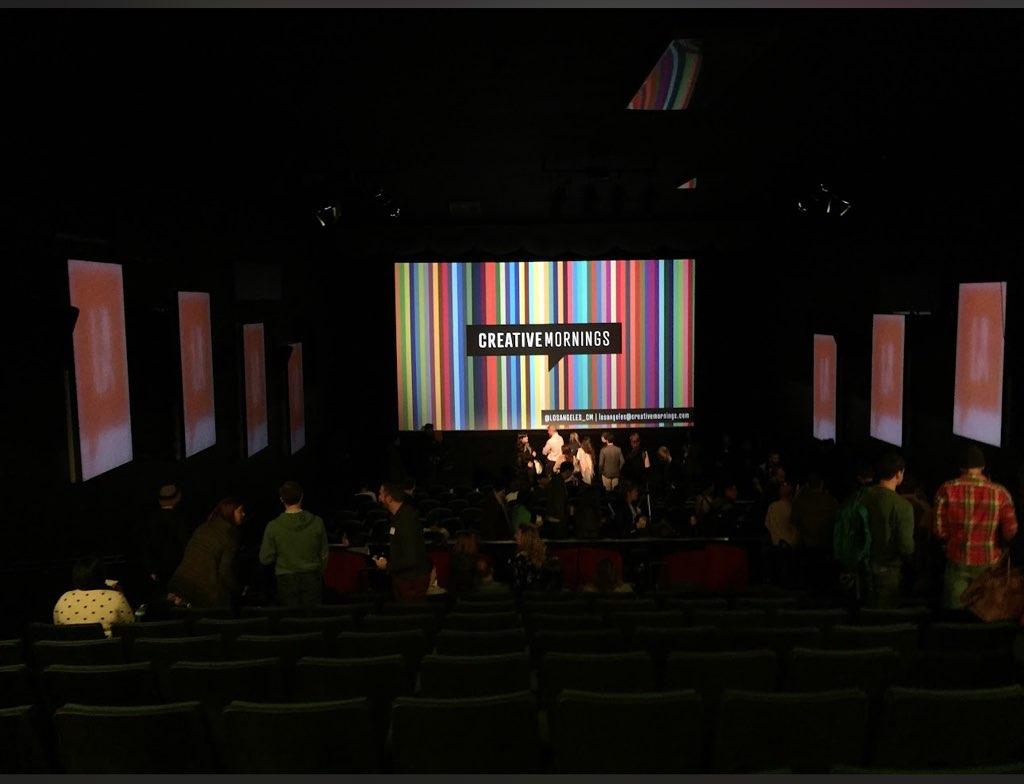 A morning talk in the theater with graphics on the main screen