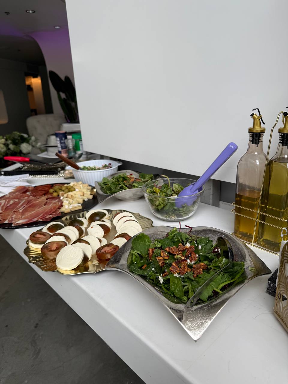 Charcuterie, caprese and salads laid out on the lobby bar