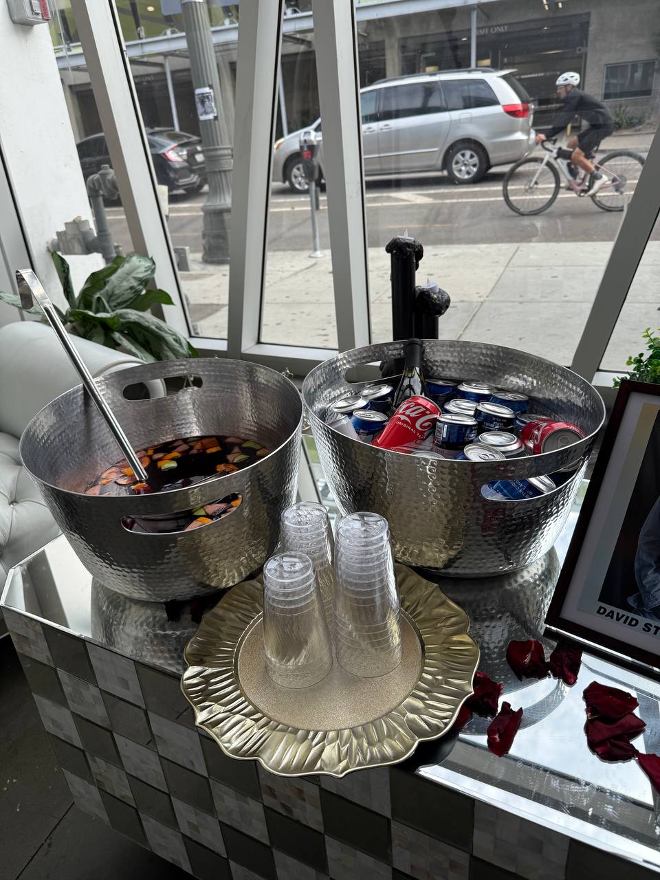 Punch bowl and chilled drinks staged at the window bar with rose petals