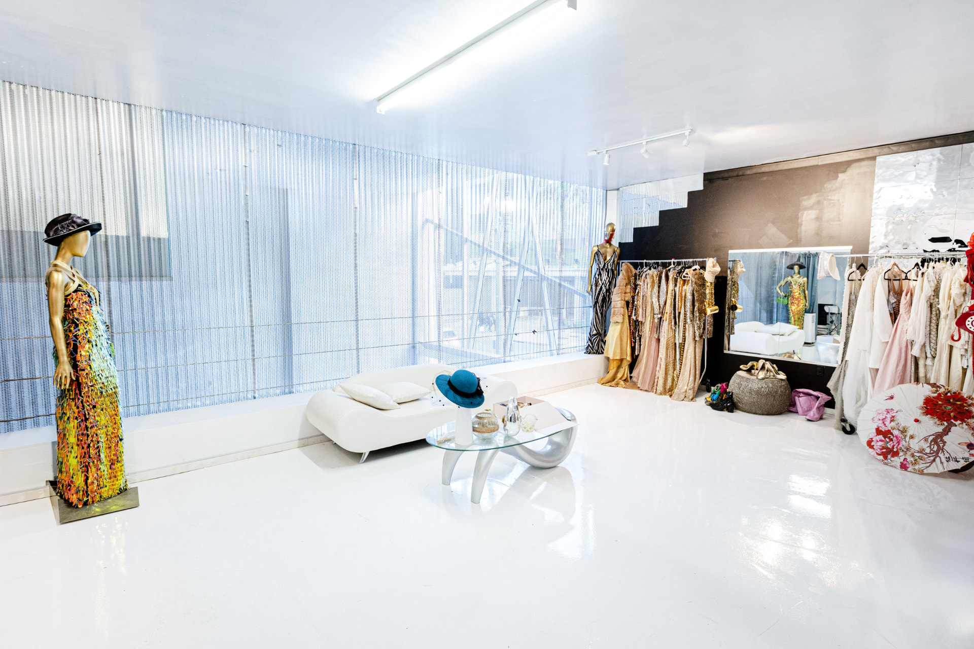 The styling suite in daylight with mannequins and racks of couture