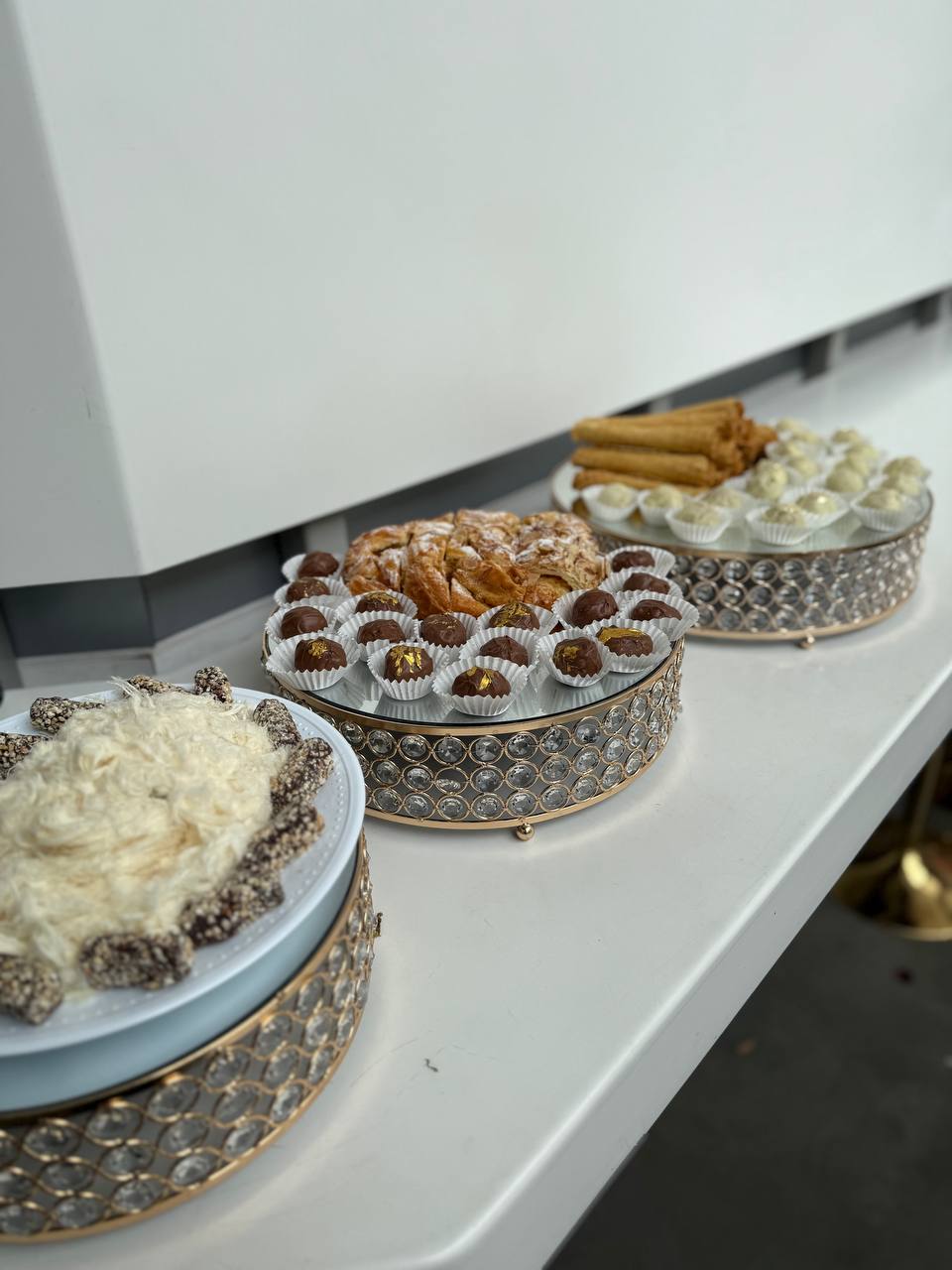 Chocolate truffles and pastries on crystal cake stands