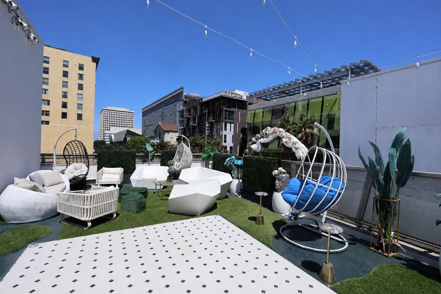 The rooftop terrace in daylight with swing chairs and the marble dance floor