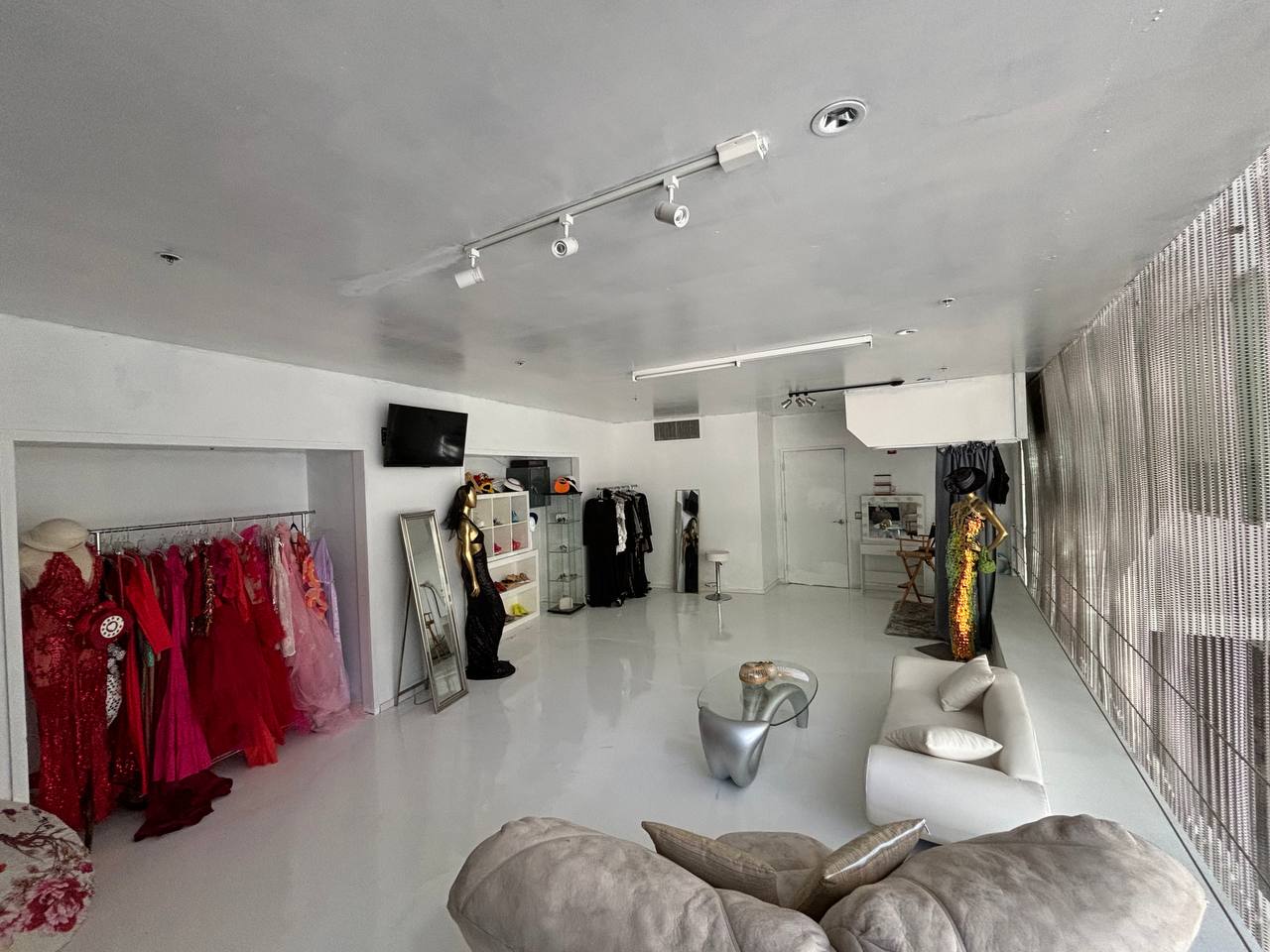 The styling suite with racks of gowns, mirrors and lounge seating
