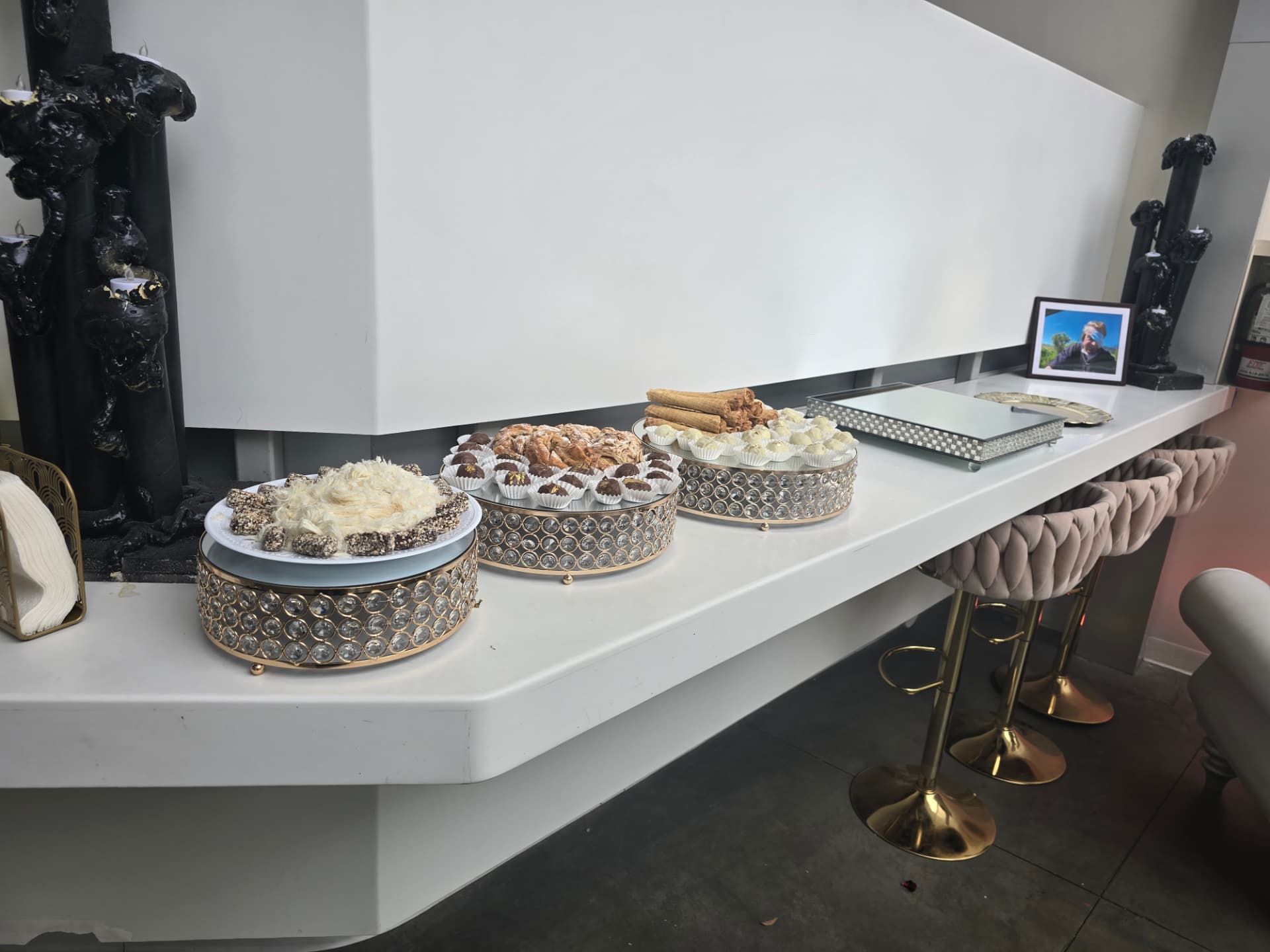 A dessert bar on crystal and gold stands along the lobby counter