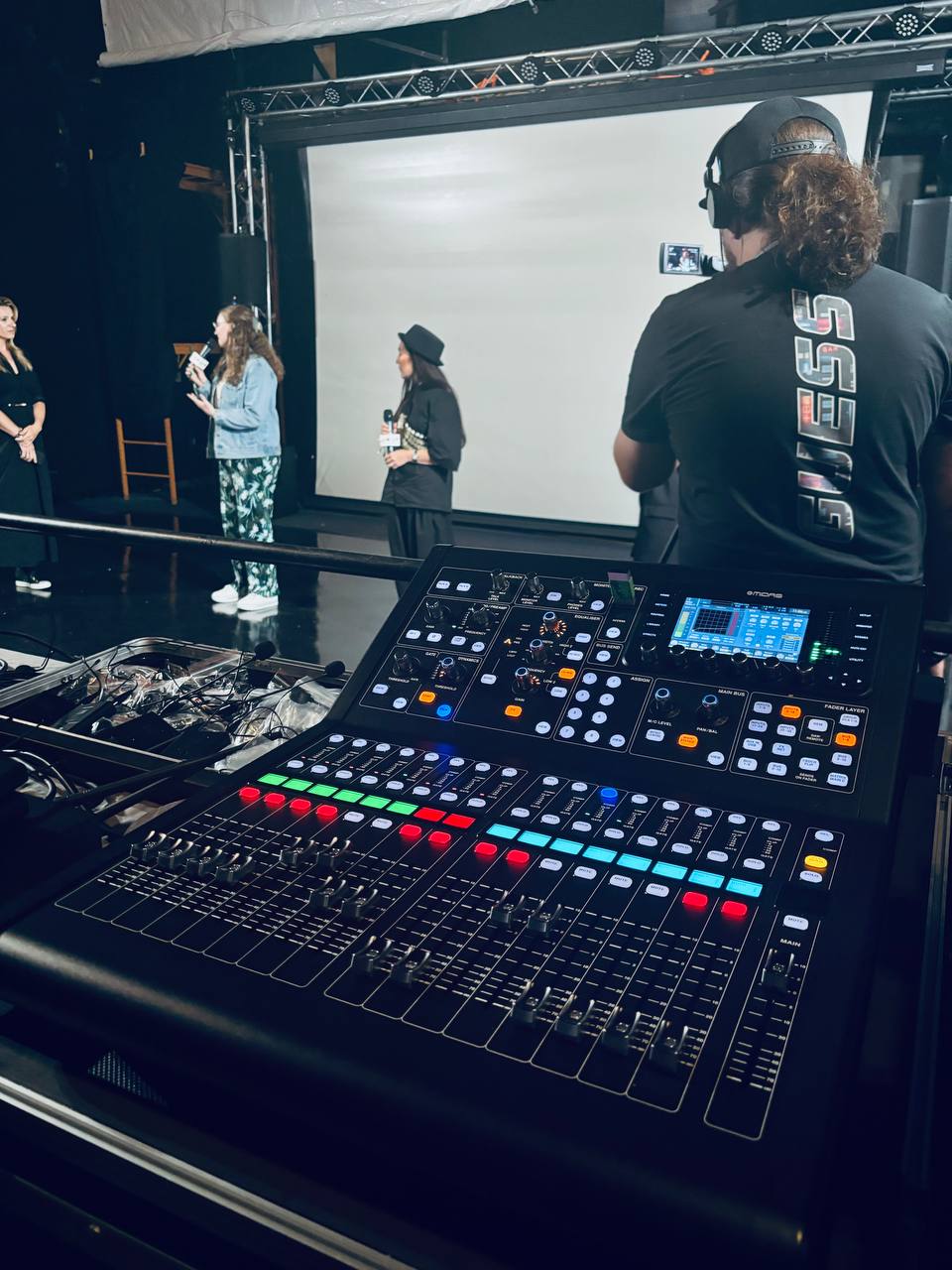 The front-of-house audio console with the stage beyond