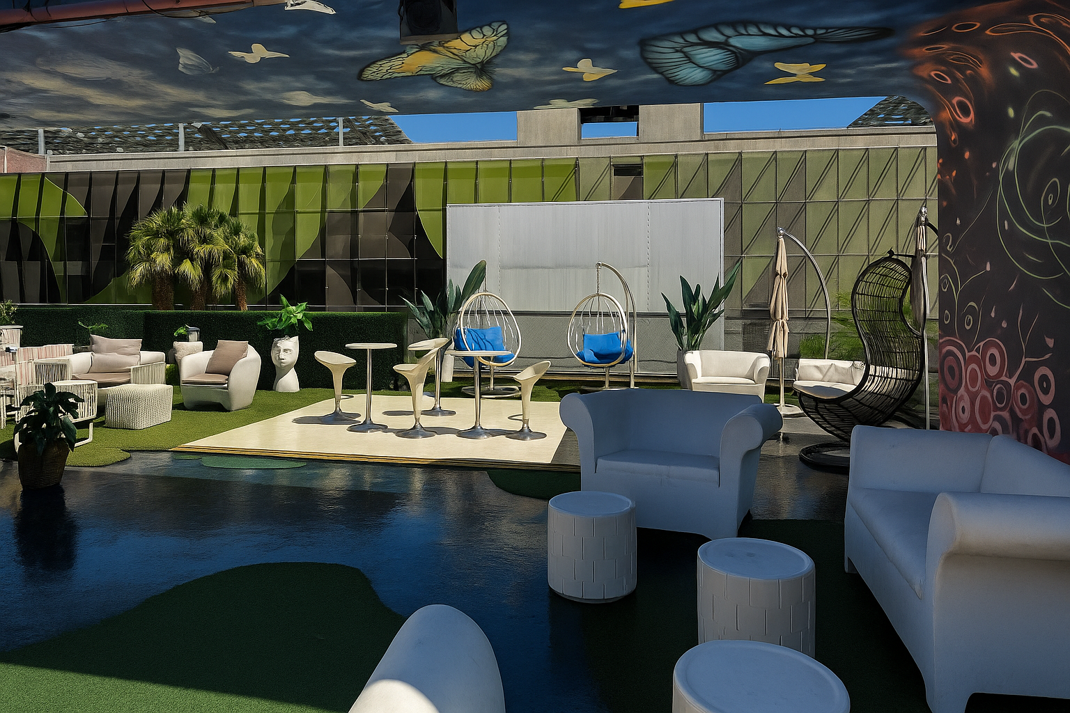 The rooftop lounge in daylight under the butterfly mural ceiling