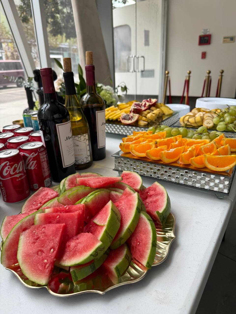 Watermelon and citrus platters with wine at the window bar