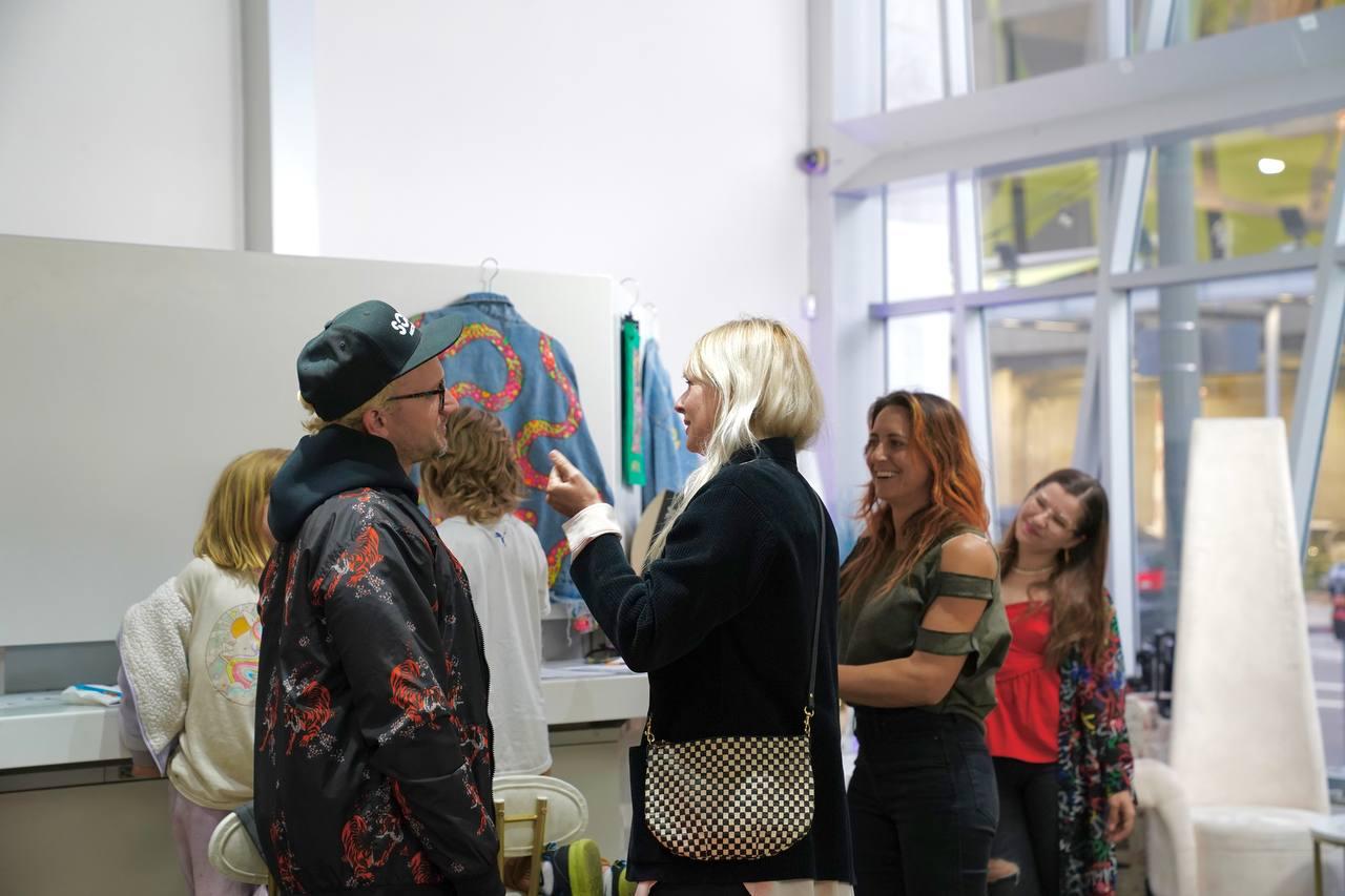 Guests gathered around an apparel display in the atrium