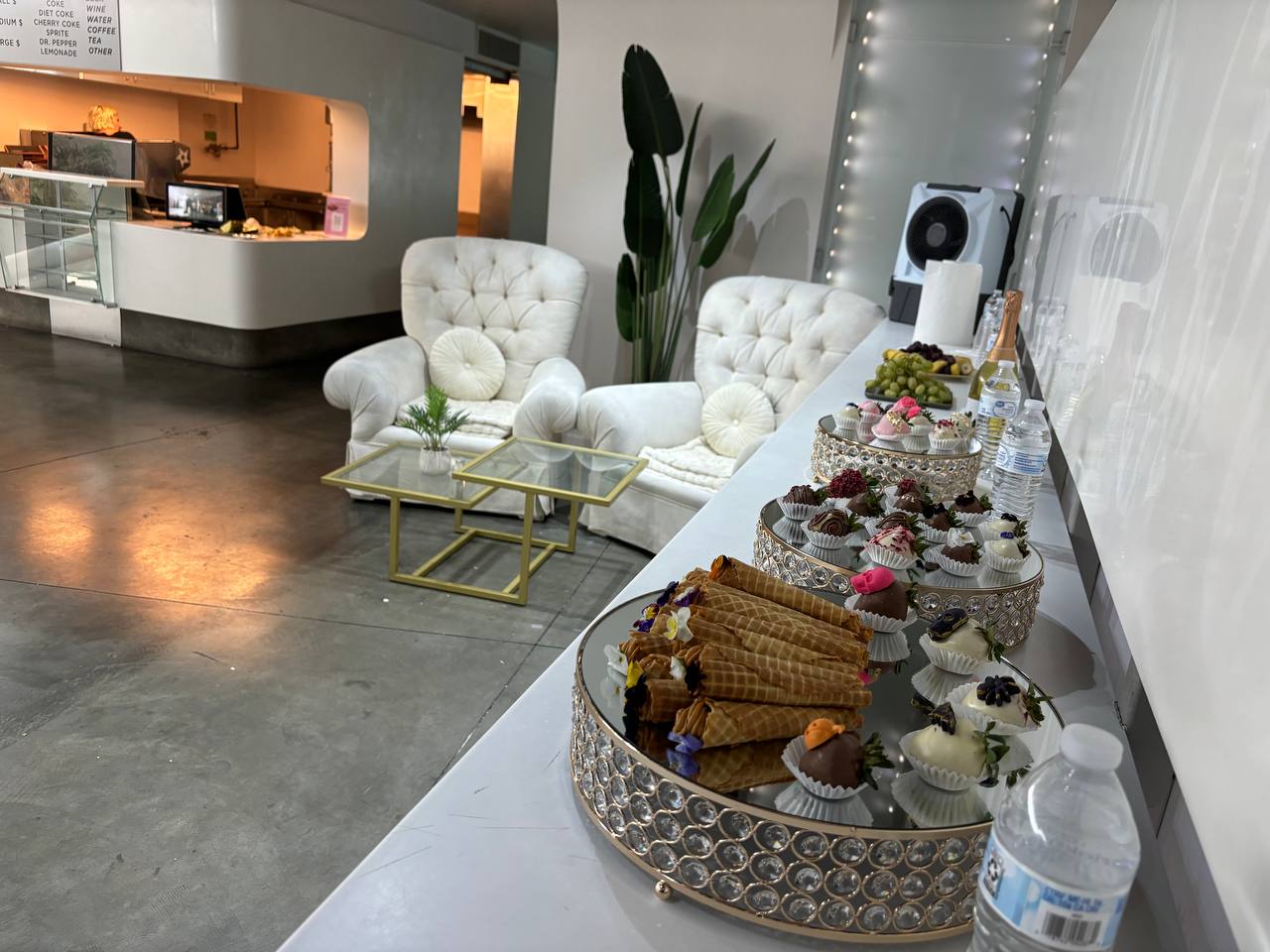 Tufted white lounge seating beside the dessert bar in the lobby