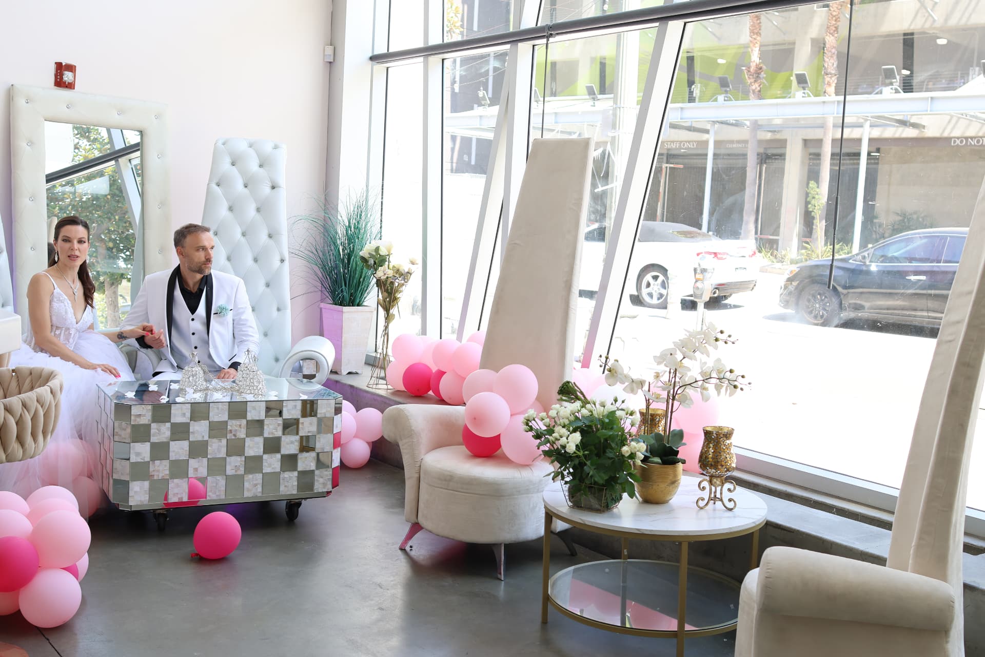 The atrium styled with pink balloons, florals and mirrored furniture